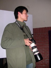 A Chinese Dude with a big camera lense