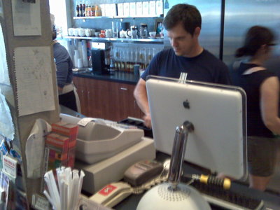 Matt Bishops works the till