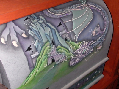 A hand painted chest with a dragon on it.