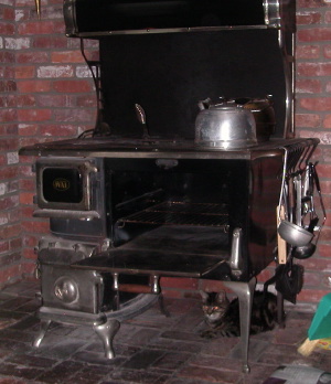 Our cat staying warm under our wood stove