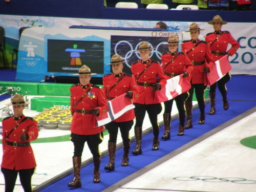 Mounties carry flags for curling medal ceremony